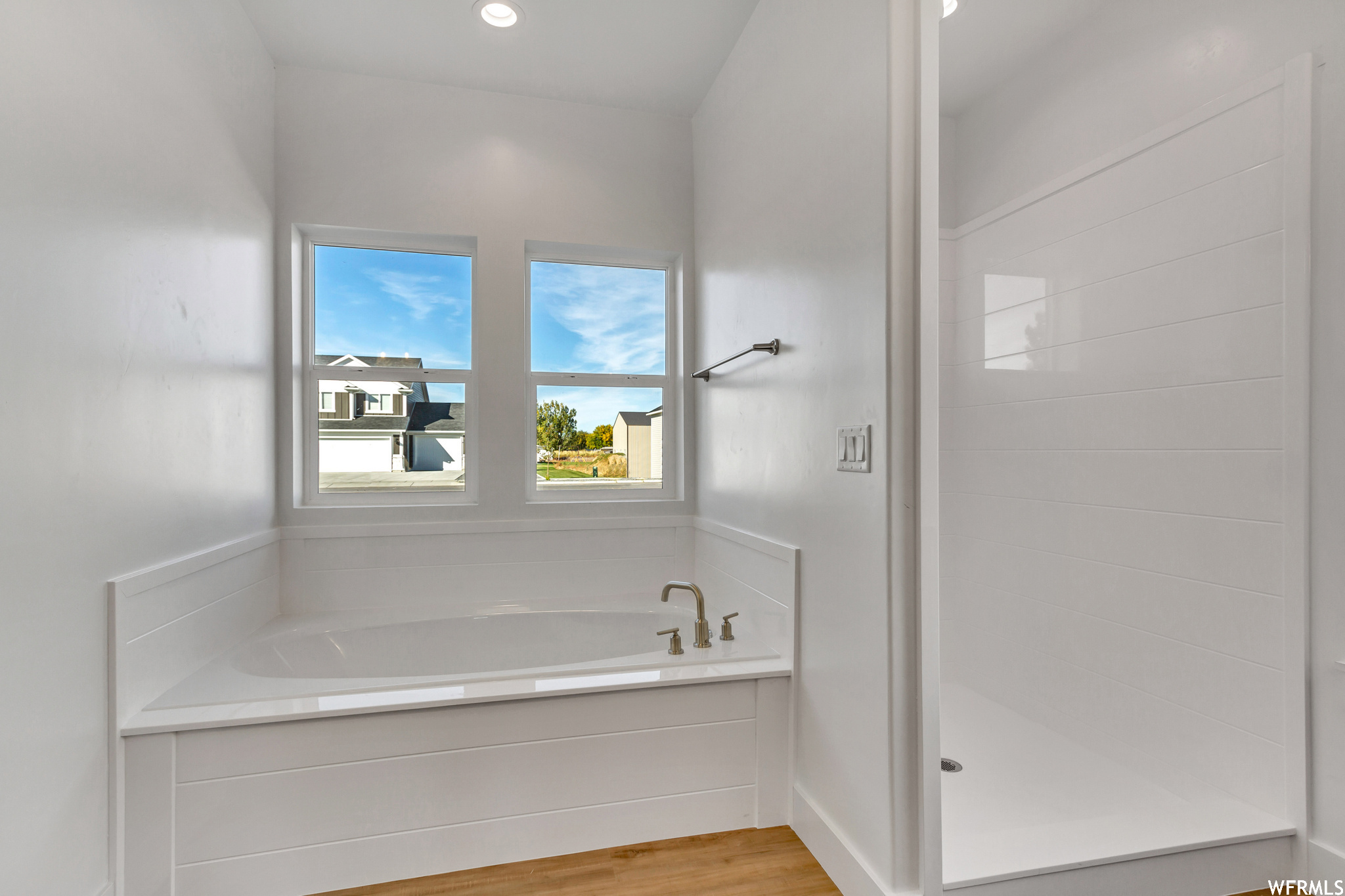 Bathroom with wood-type flooring and a bathtub