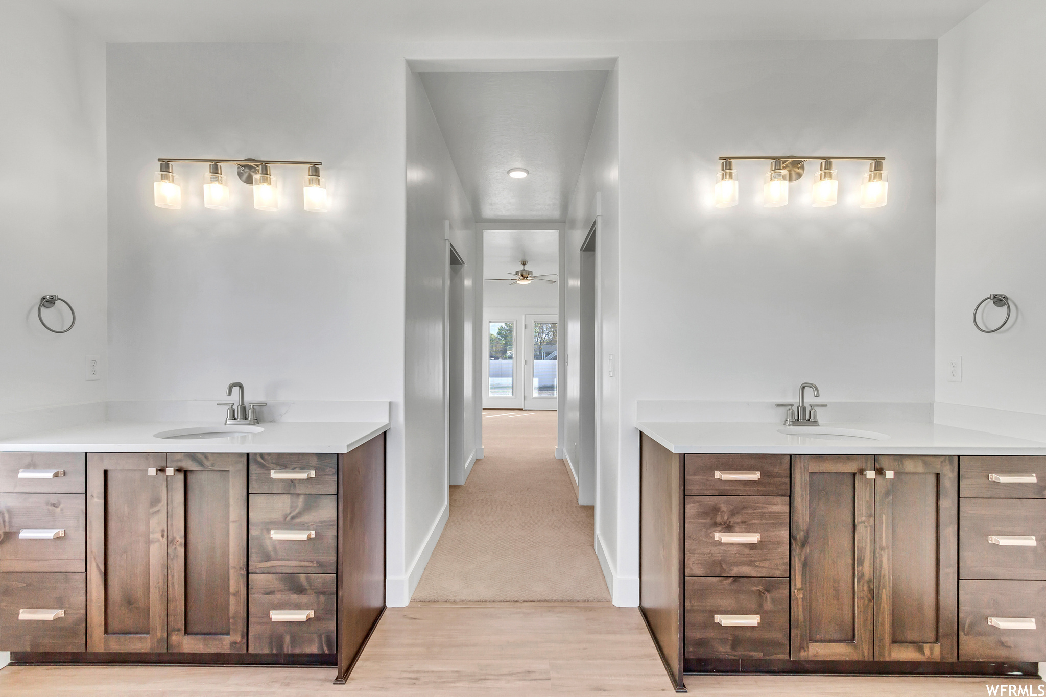 Bathroom with ceiling fan, dual bowl vanity, and hardwood / wood-style flooring