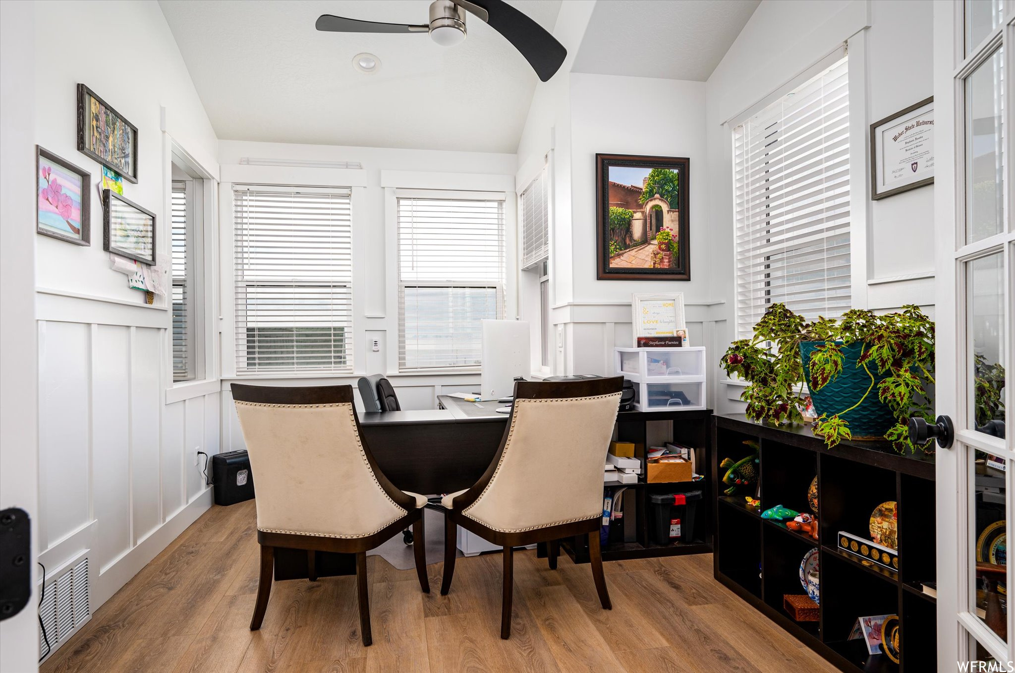 Office area featuring light hardwood / wood-style flooring, ceiling fan, and vaulted ceiling