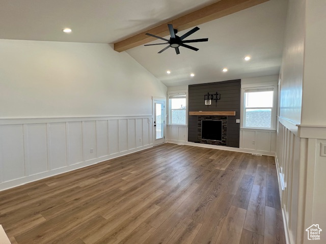 Unfurnished living room with lofted ceiling with beams, ceiling fan, hardwood / wood-style floors, and a fireplace