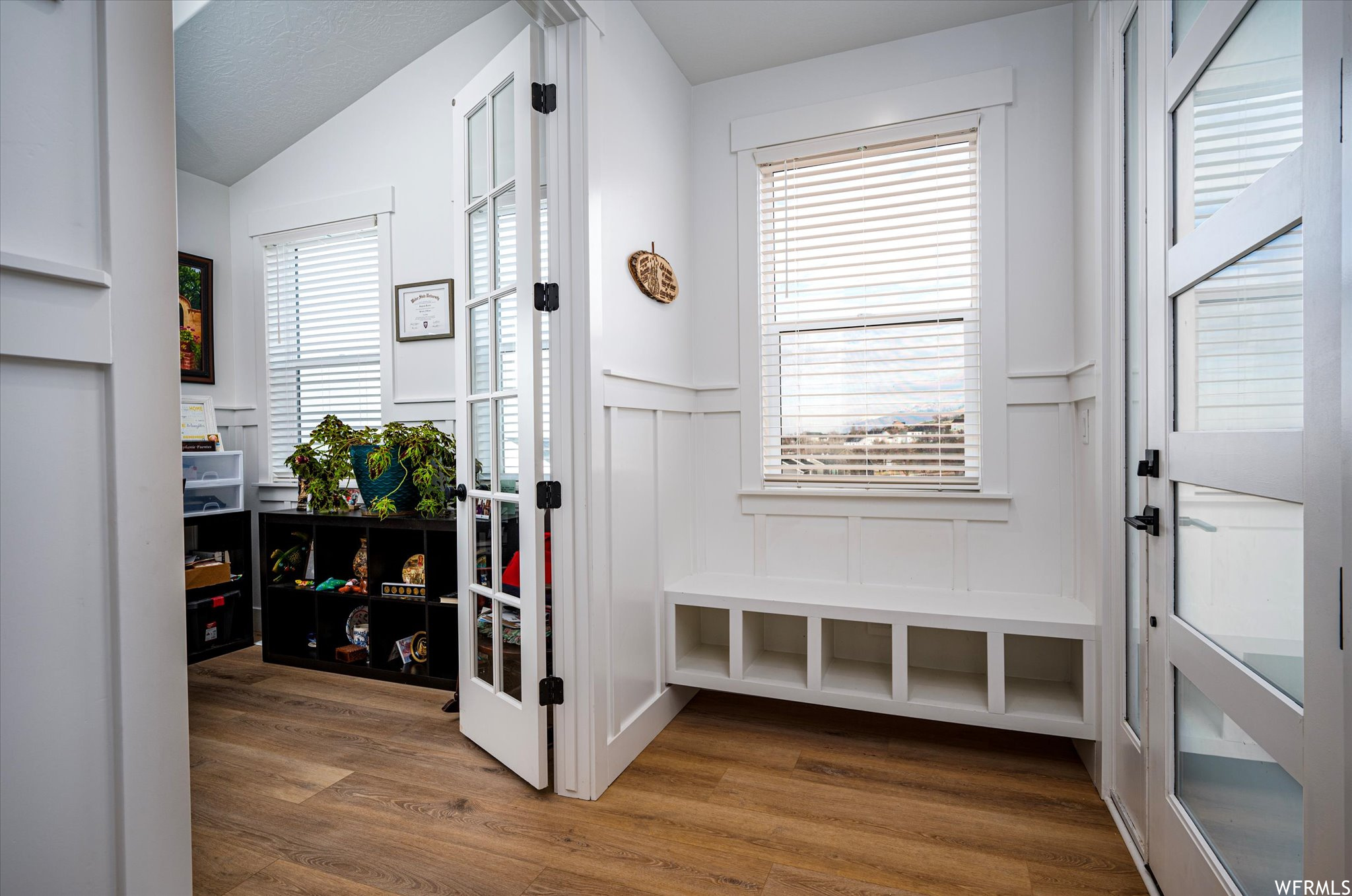 Mudroom featuring vaulted ceiling and hardwood / wood-style flooring