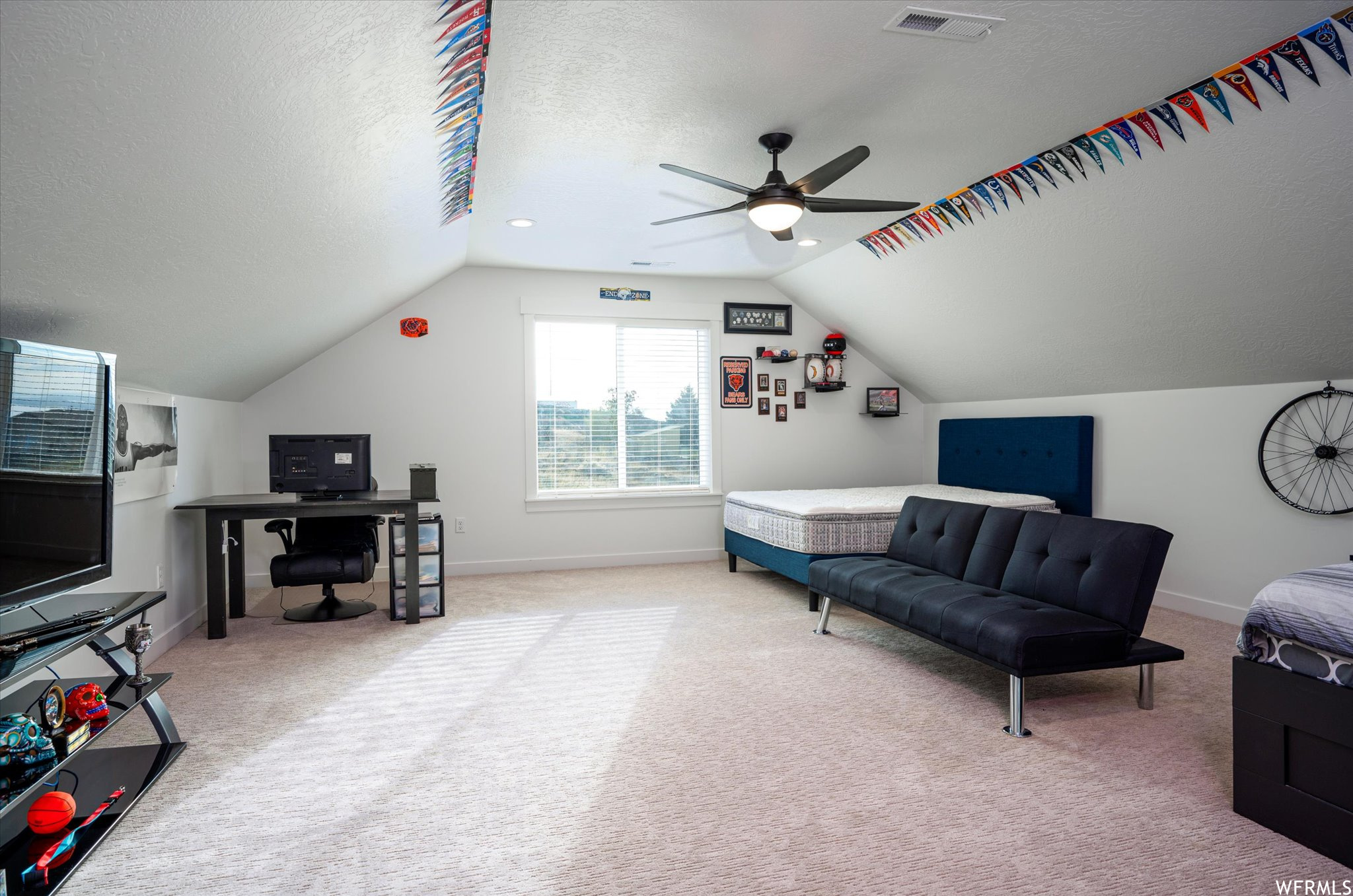 Sitting room with lofted ceiling, light colored carpet, ceiling fan, and a textured ceiling