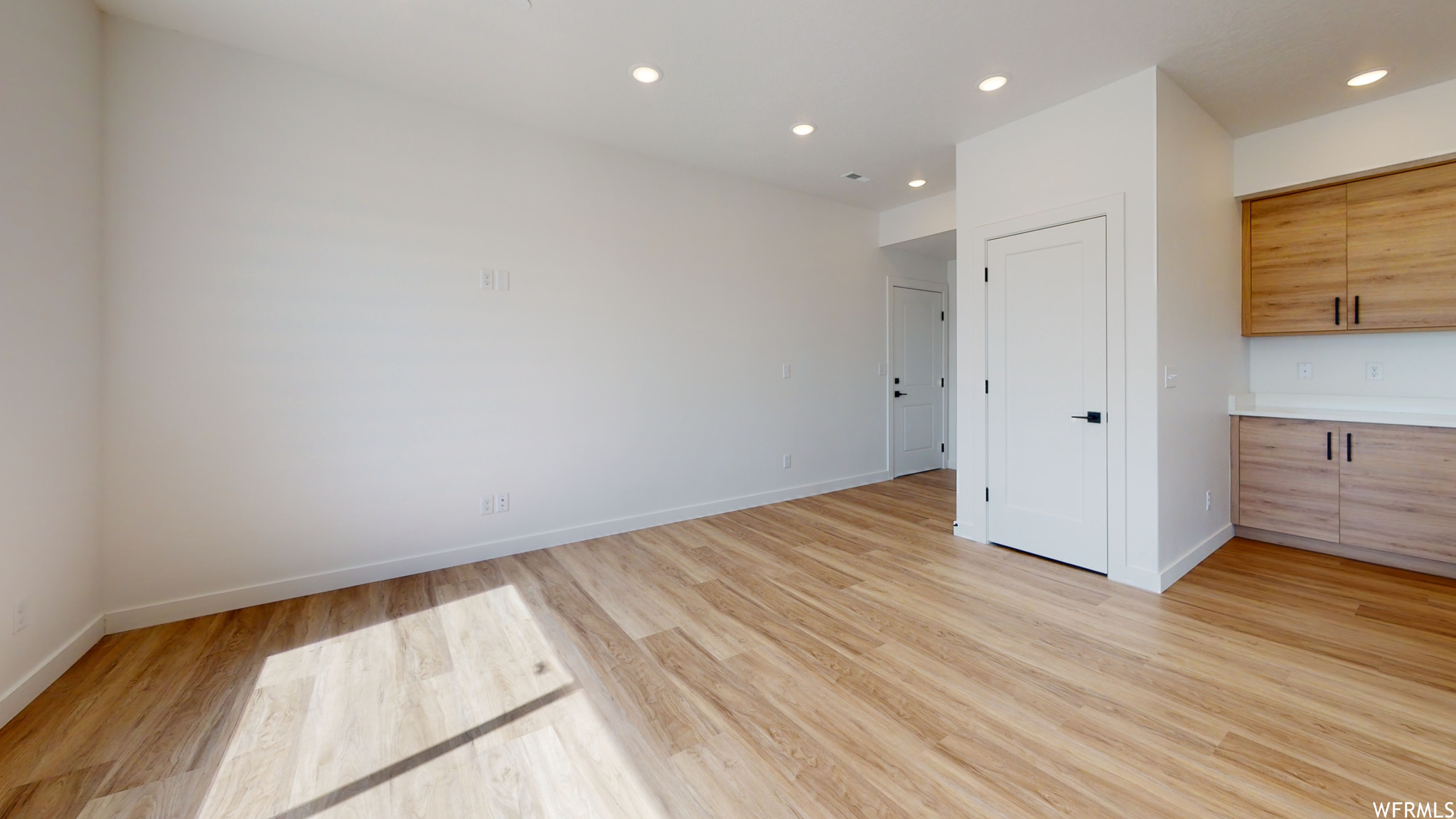 Unfurnished bedroom with light hardwood / wood-style floors