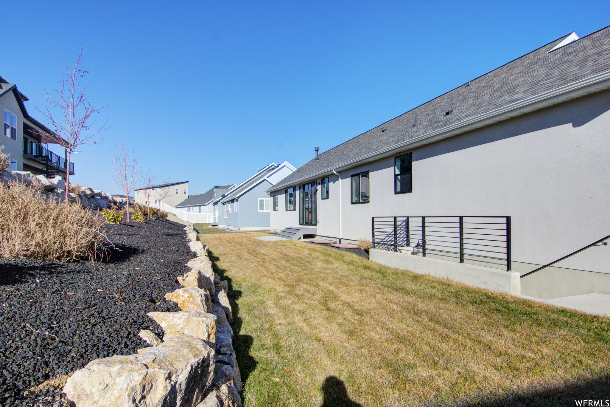 Backyard with Rockwall, Landscaping & exterior basement entrance