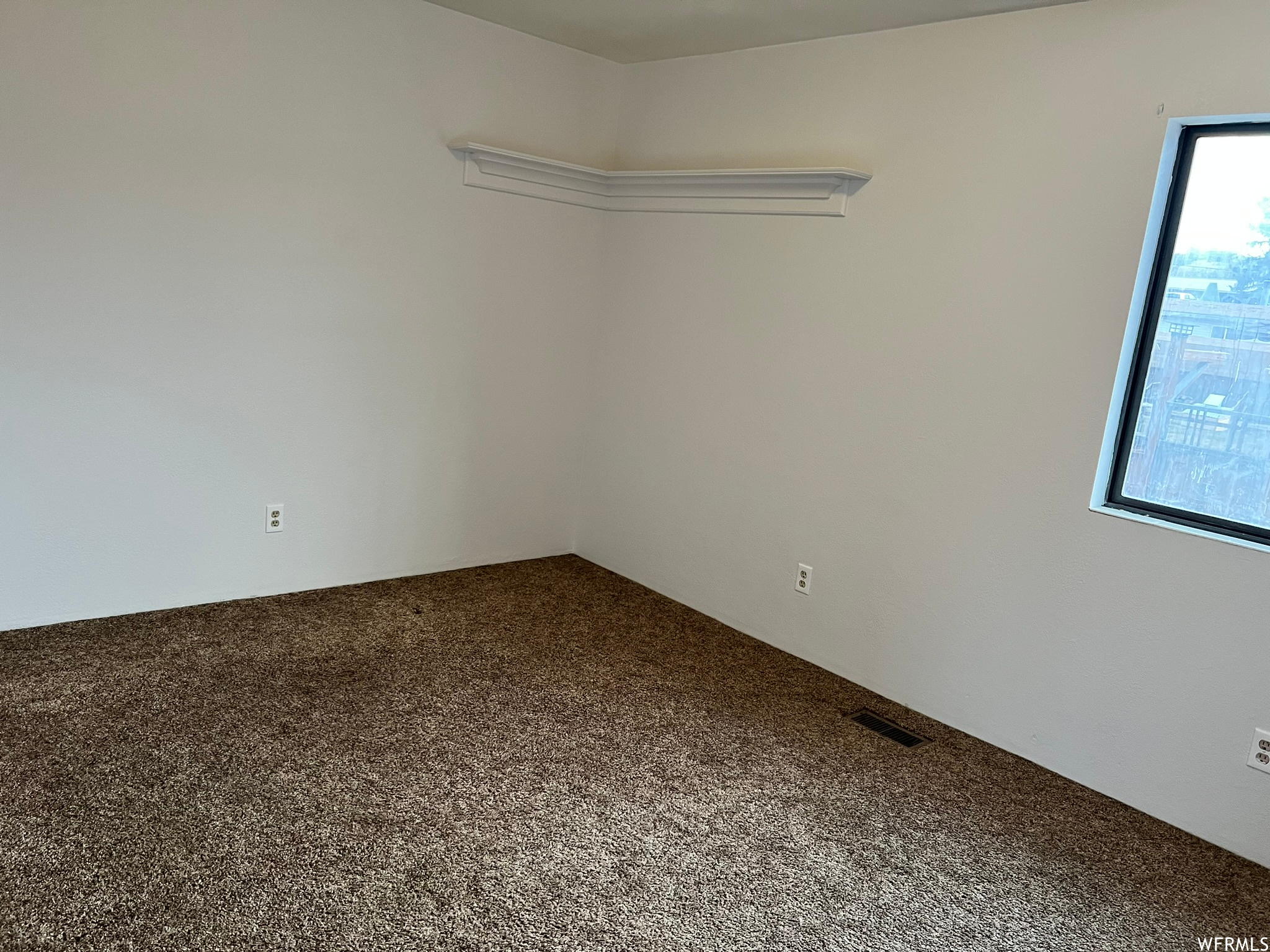 Unfurnished room featuring carpet