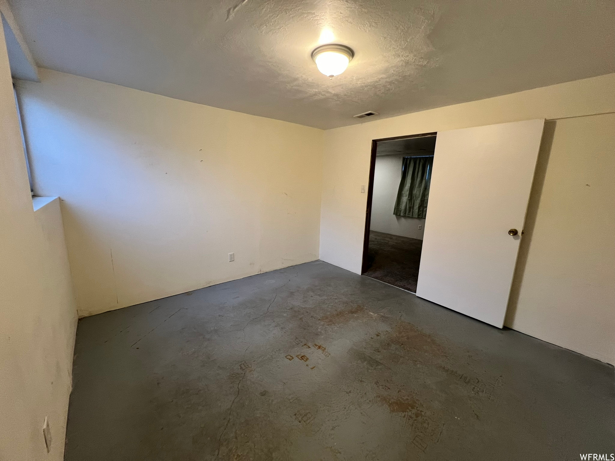 Basement bedroom with a textured ceiling