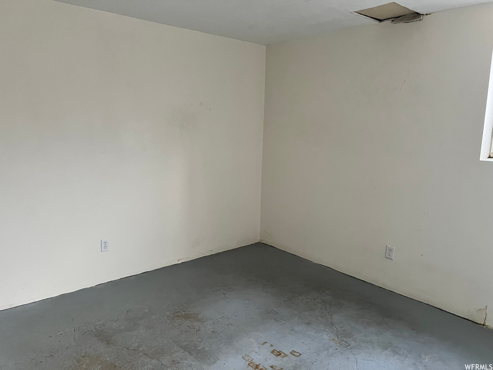 Basement bedroom with concrete flooring