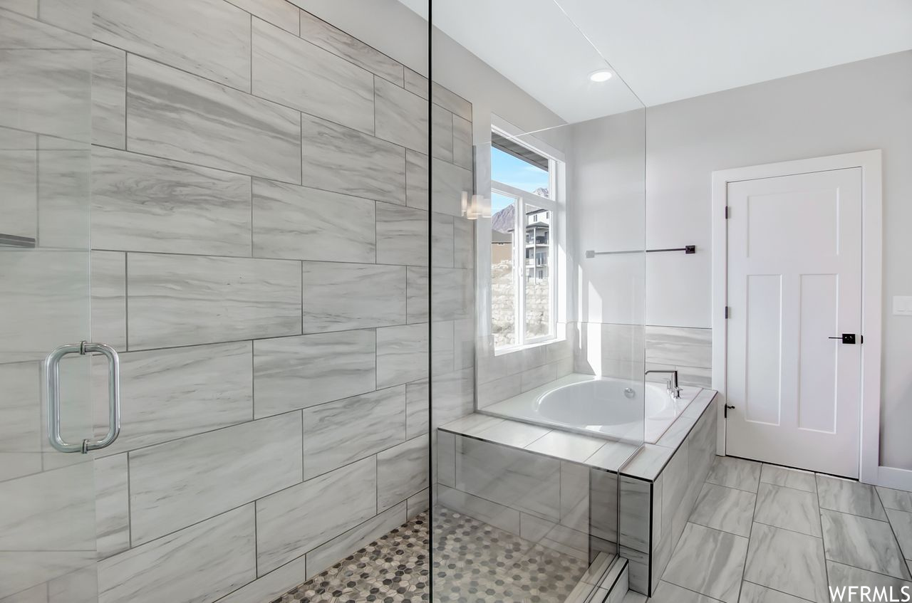 Primary bathroom with separate tub and walk-in shower