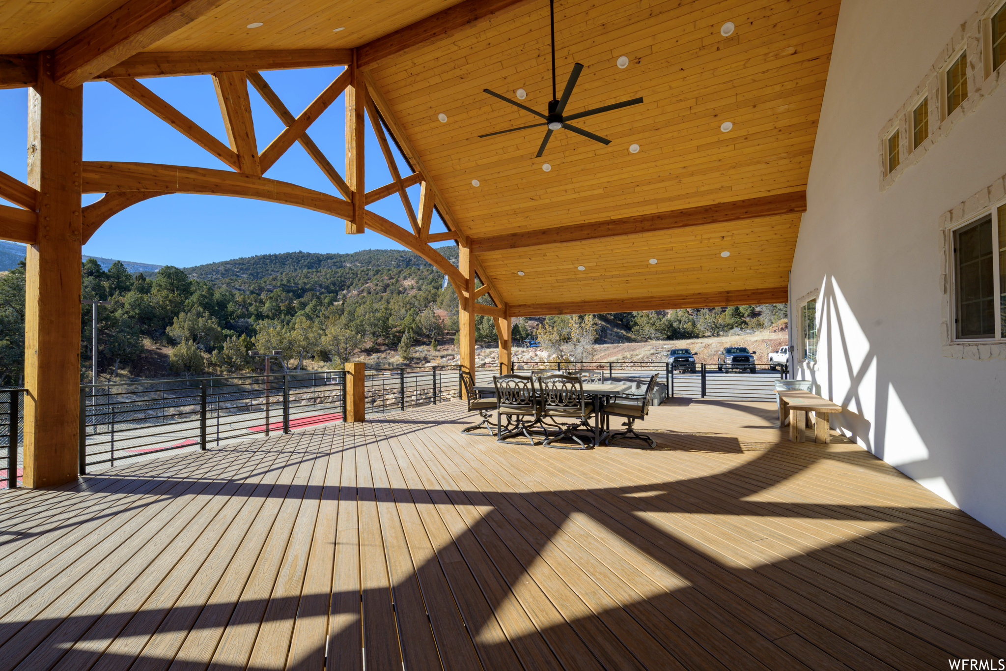 Deck with ceiling fan and a mountain view