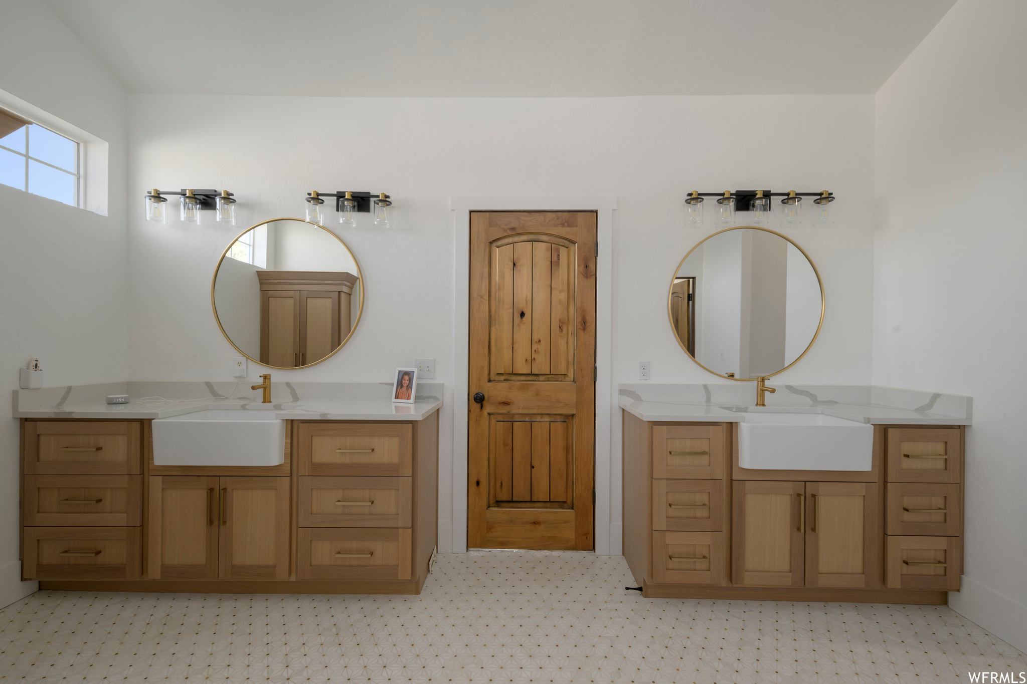 Bathroom featuring tile floors and dual vanity