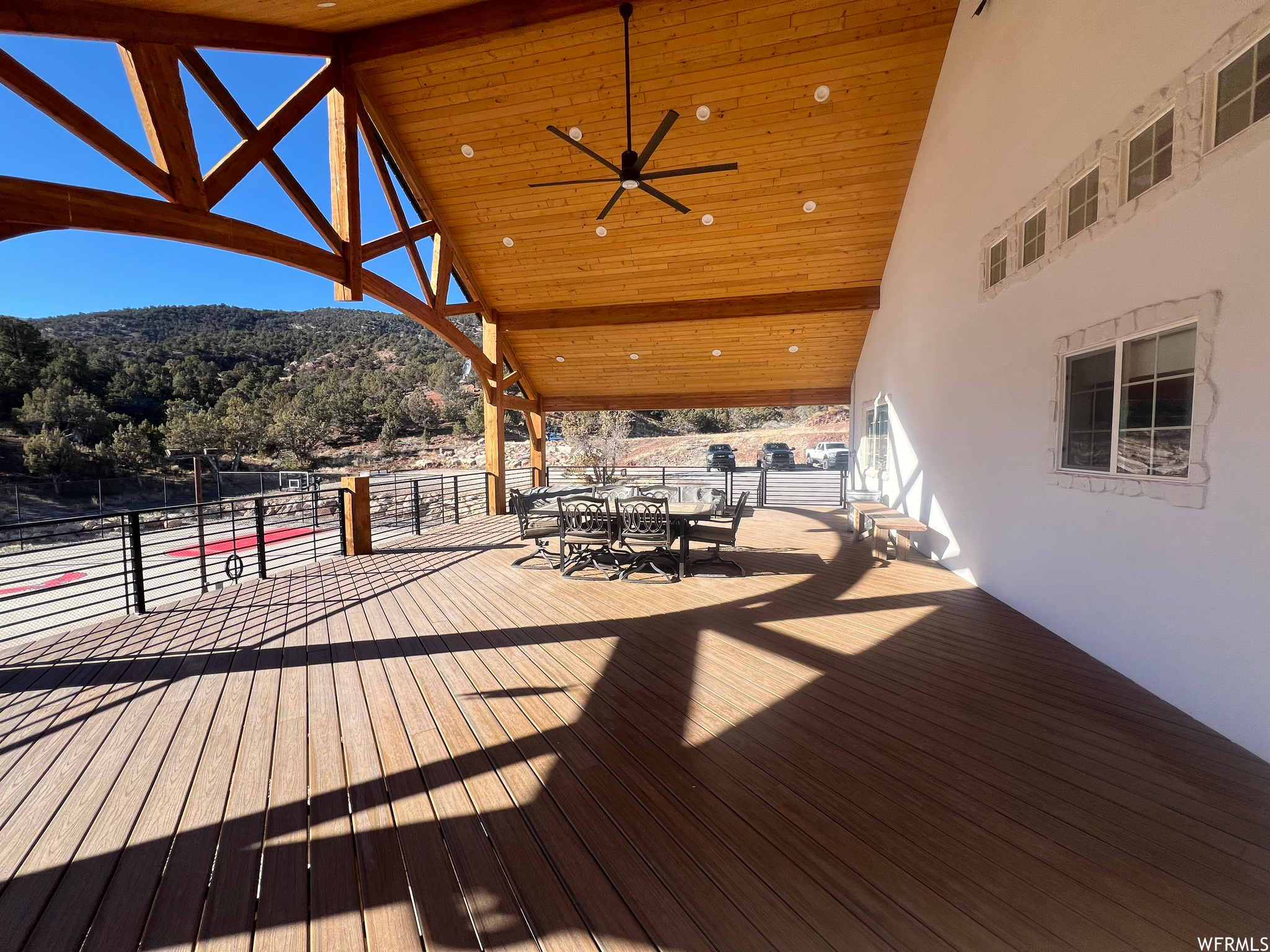 Wooden terrace with ceiling fan and a mountain view