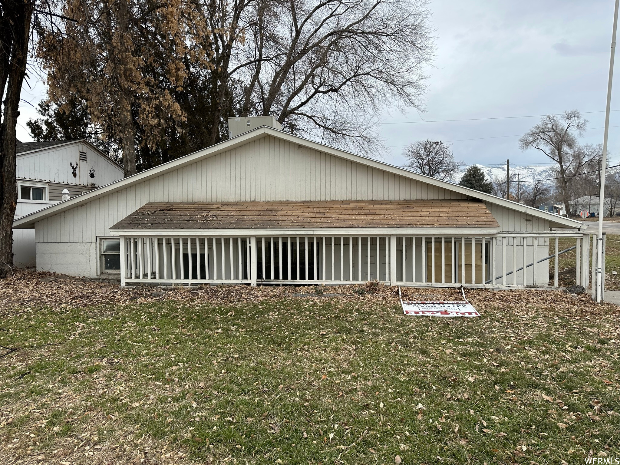 View of side of property with a sunroom and a lawn