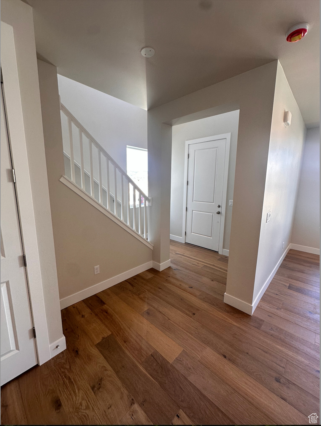 Hall with hardwood / wood-style floors