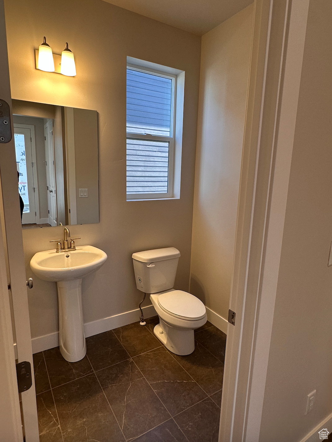 Bathroom with toilet and tile patterned floors