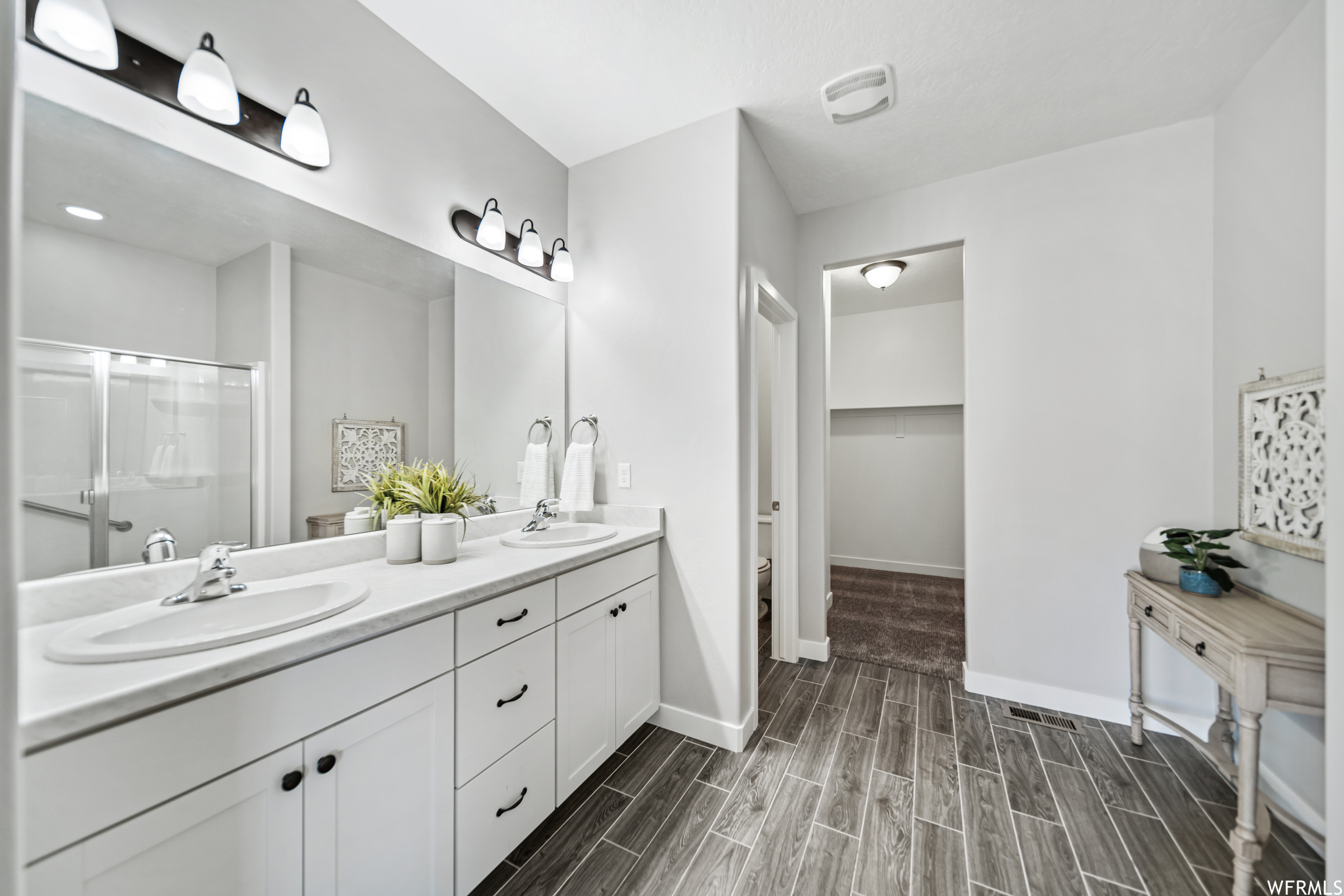 Primary bathroom with double vanity and oversized, walk-in closet