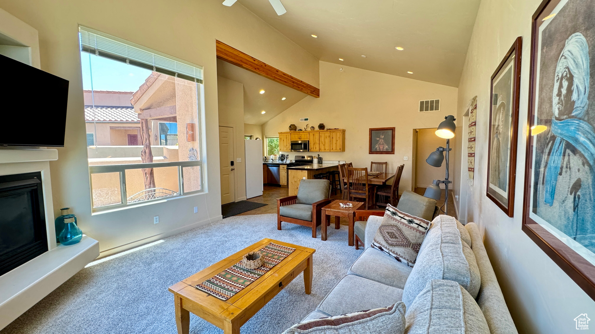 Carpeted living room with high vaulted ceiling