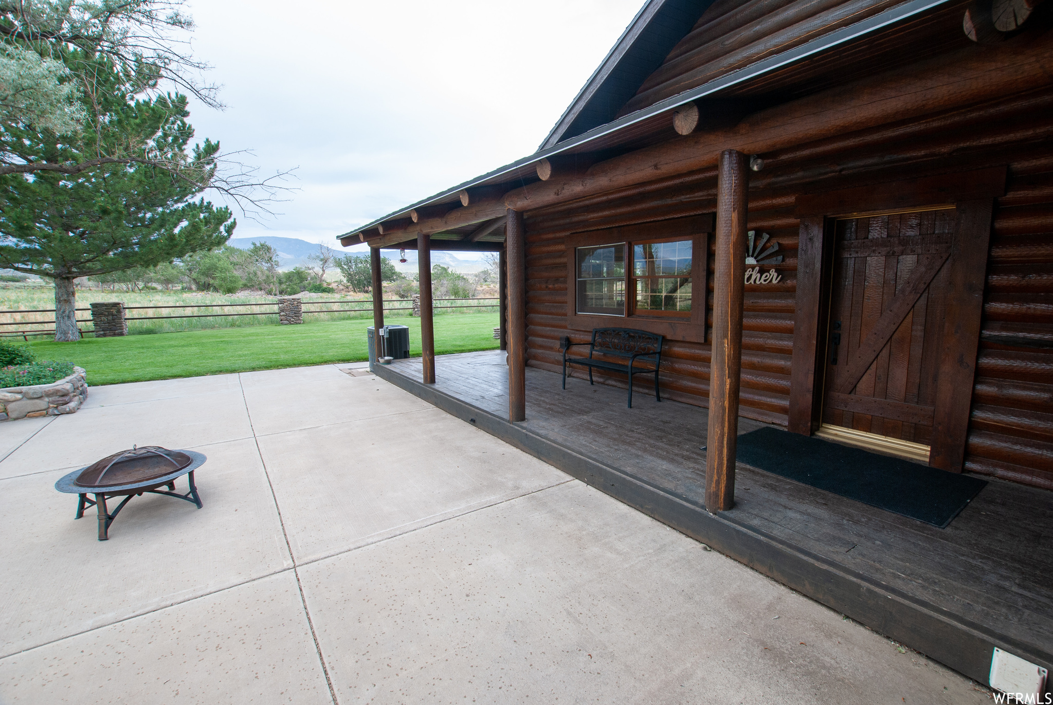 View of patio / terrace with an outdoor fire pit and a mountain view