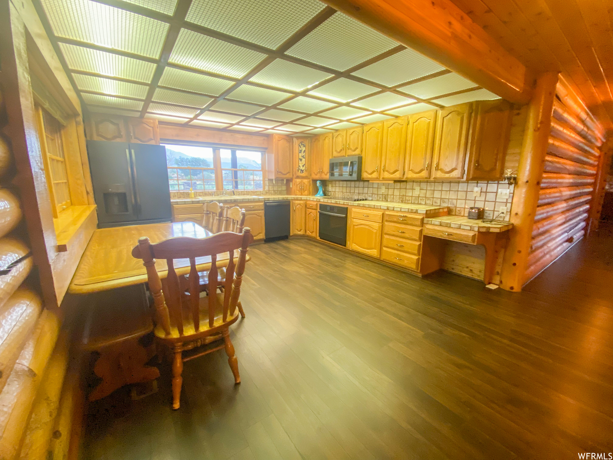 Dining room with dark hardwood / wood-style floors