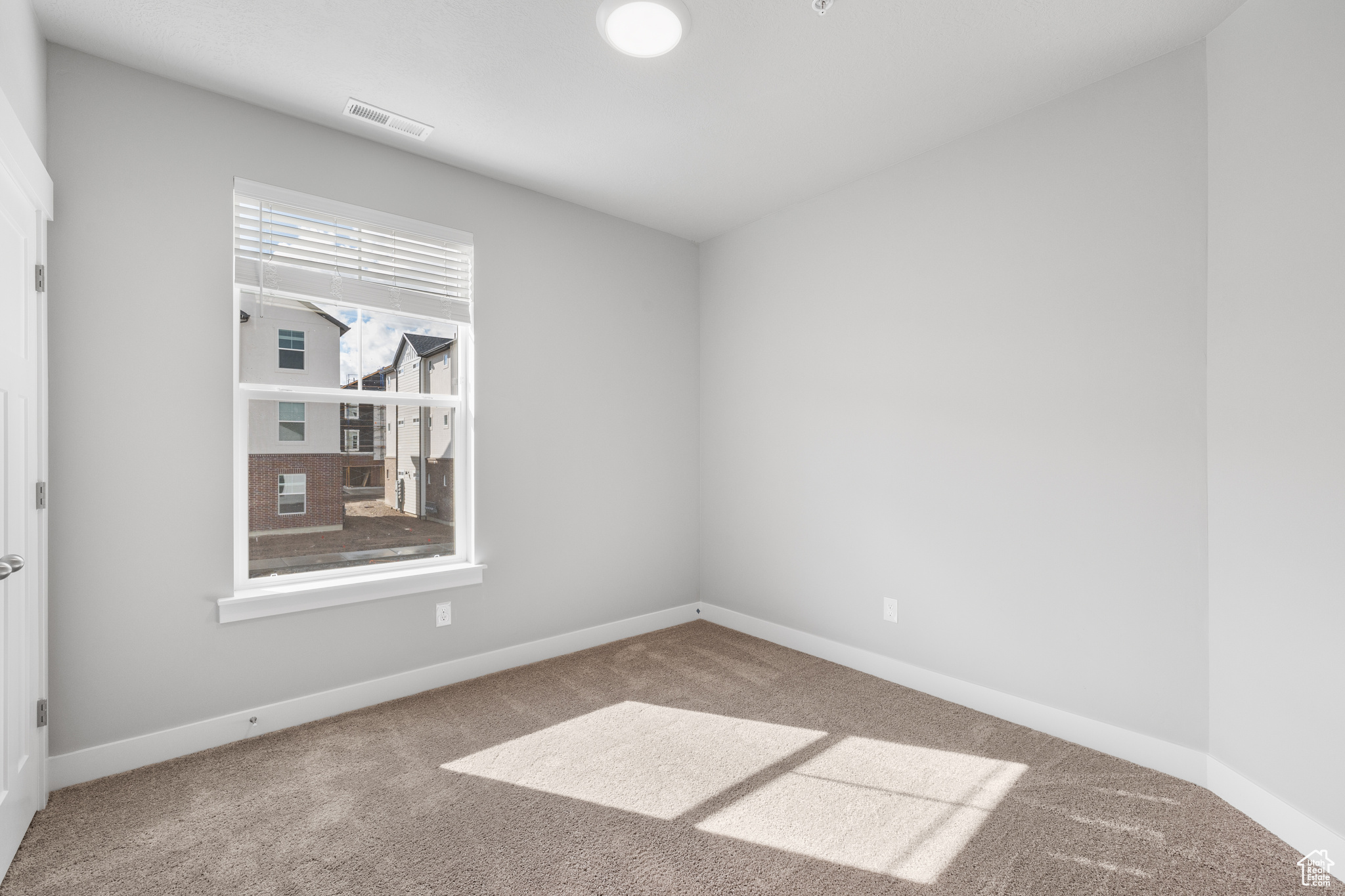 Empty room featuring carpet flooring