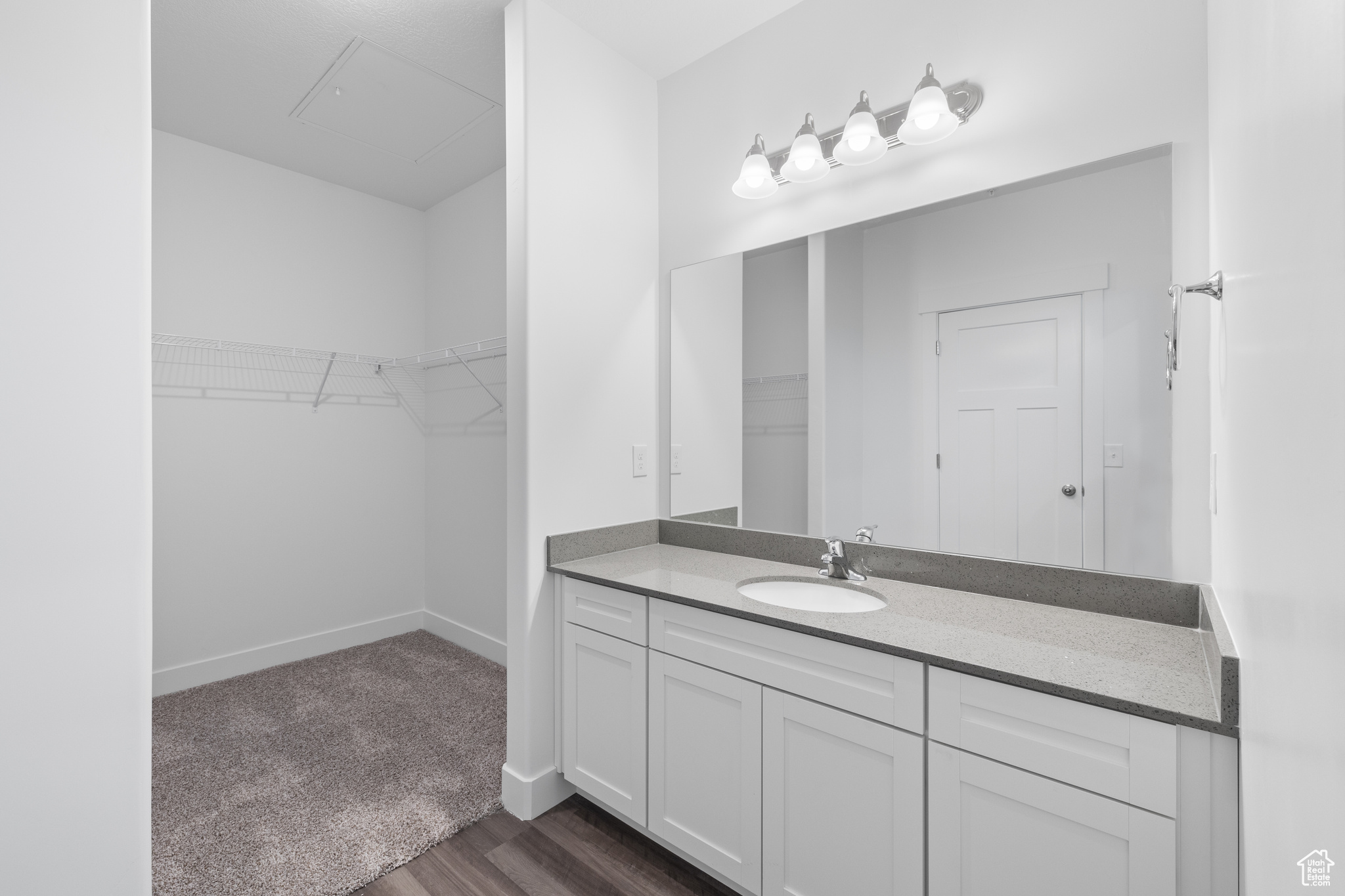 Bathroom with hardwood / wood-style flooring and vanity