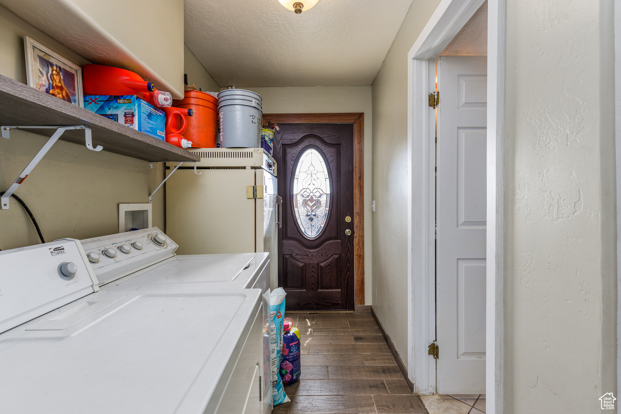 Laundry area with independent washer and dryer, dark hardwood / wood-style flooring, hookup for a washing machine, and a textured ceiling