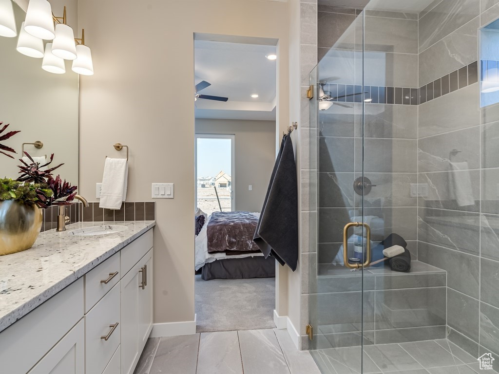 Bathroom featuring an enclosed shower, tile floors, vanity, and ceiling fan