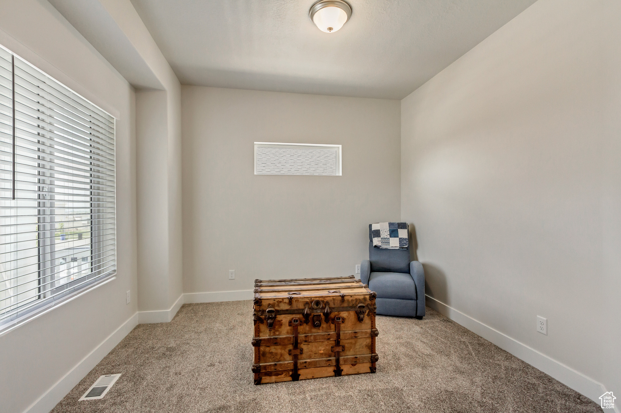 Sitting room/ or office space with light colored carpet