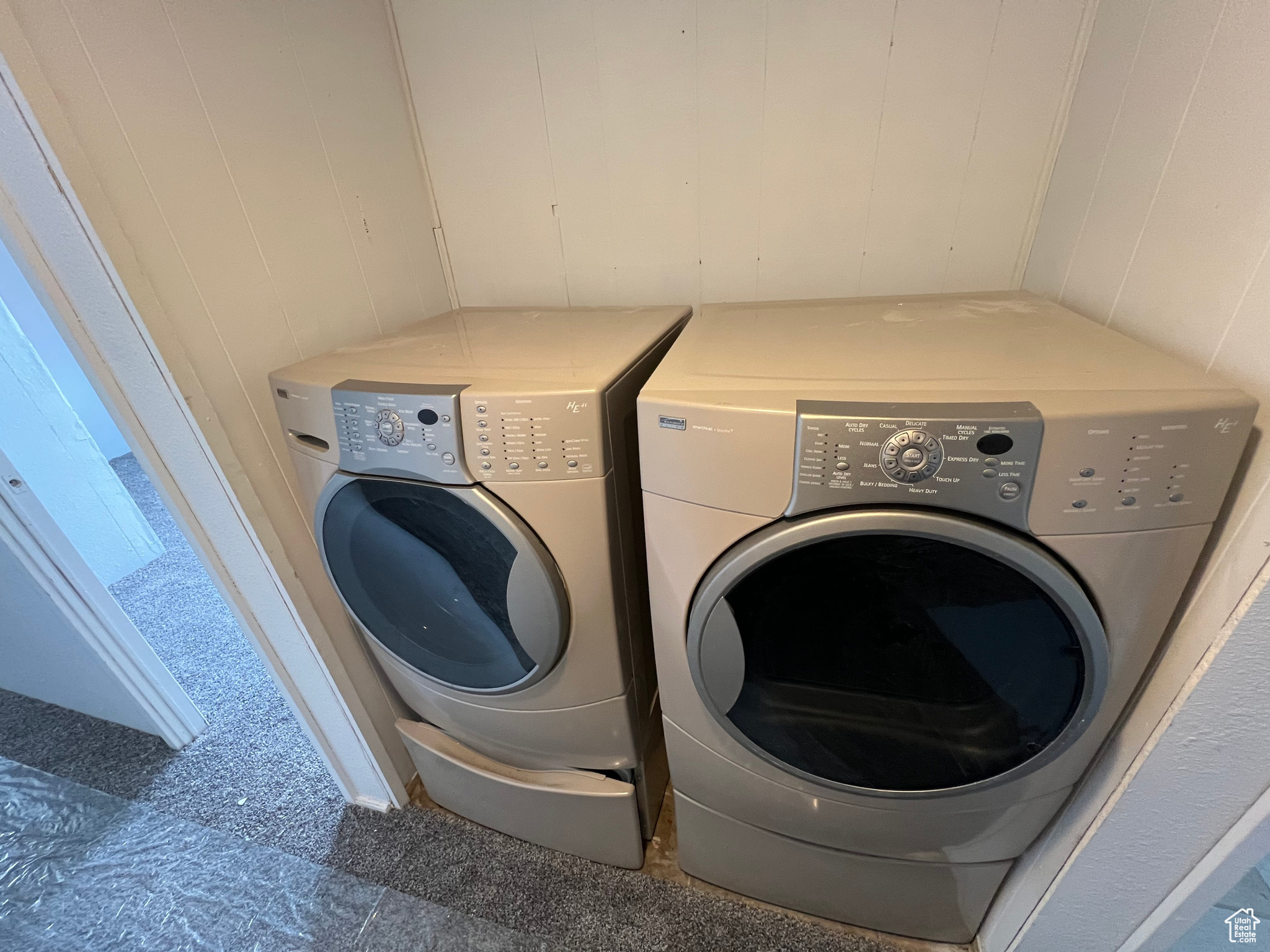 Clothes washing area featuring washer and clothes dryer and tile floors