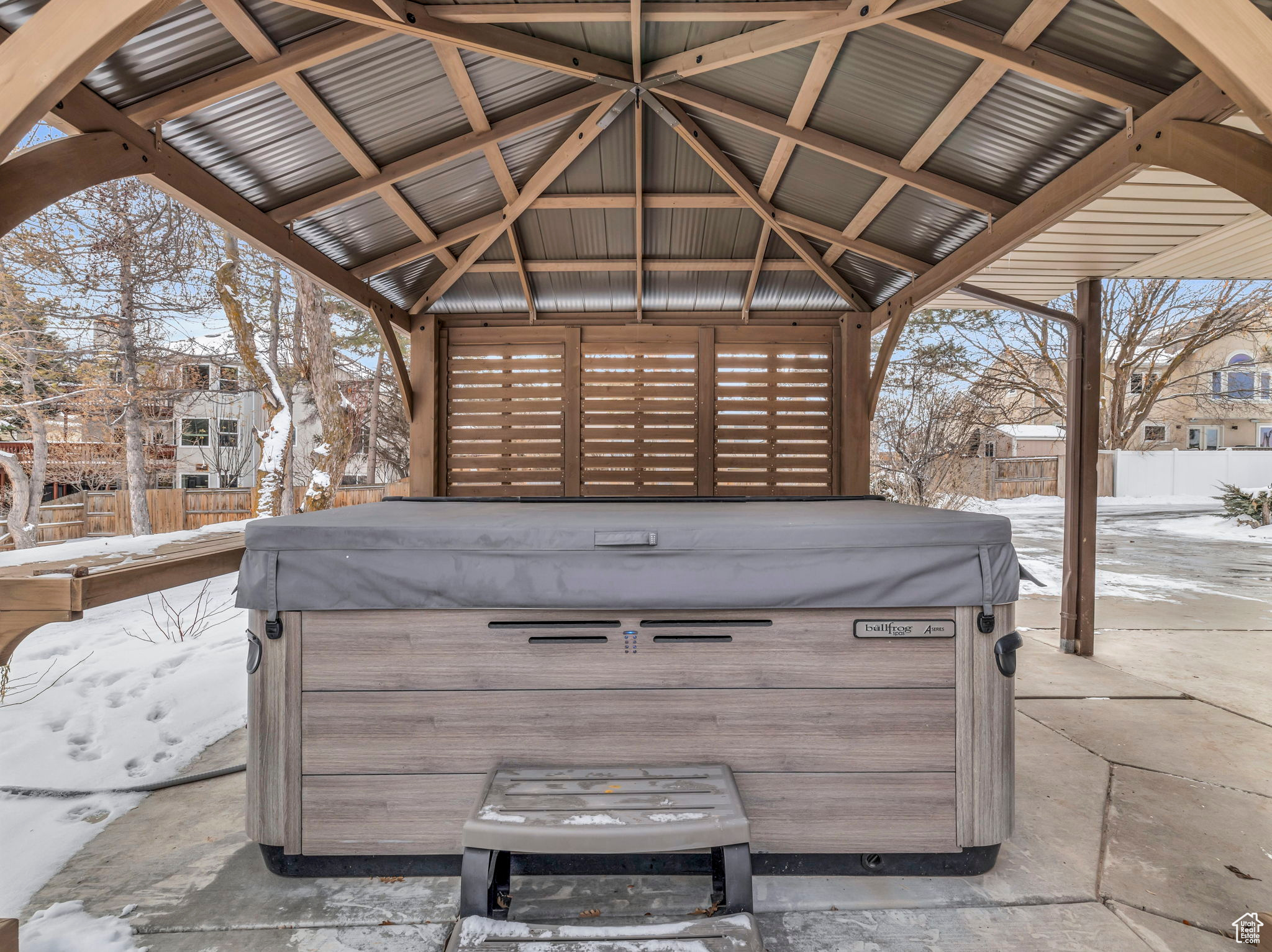 Snow covered patio featuring a gazebo and a hot tub (included in full price offer).