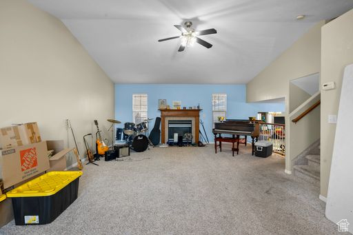 Rec room with light carpet, ceiling fan, and vaulted ceiling