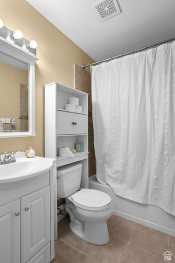 Full bathroom featuring vanity, toilet, tile flooring, and shower / bath combo