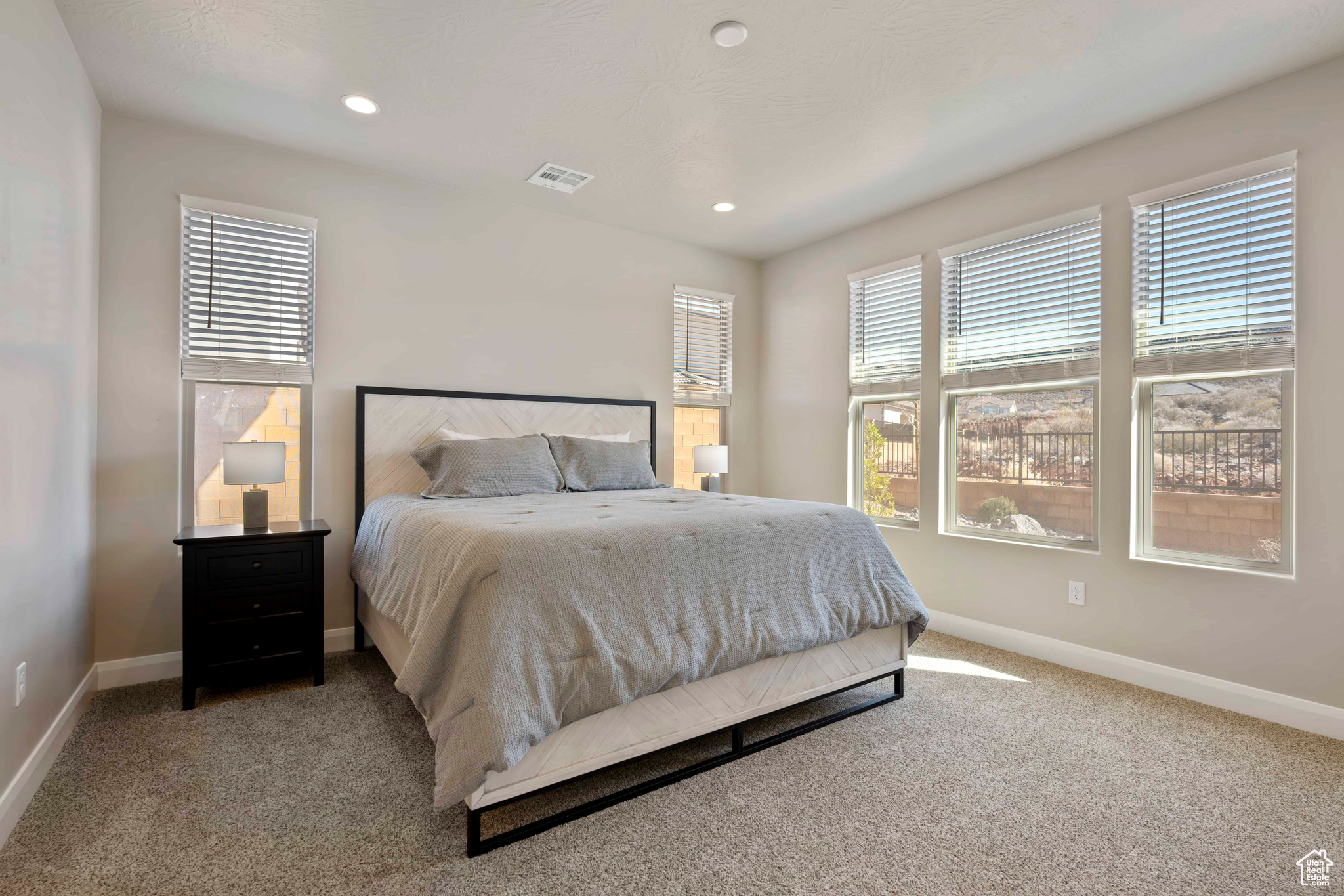 Bedroom featuring light colored carpet