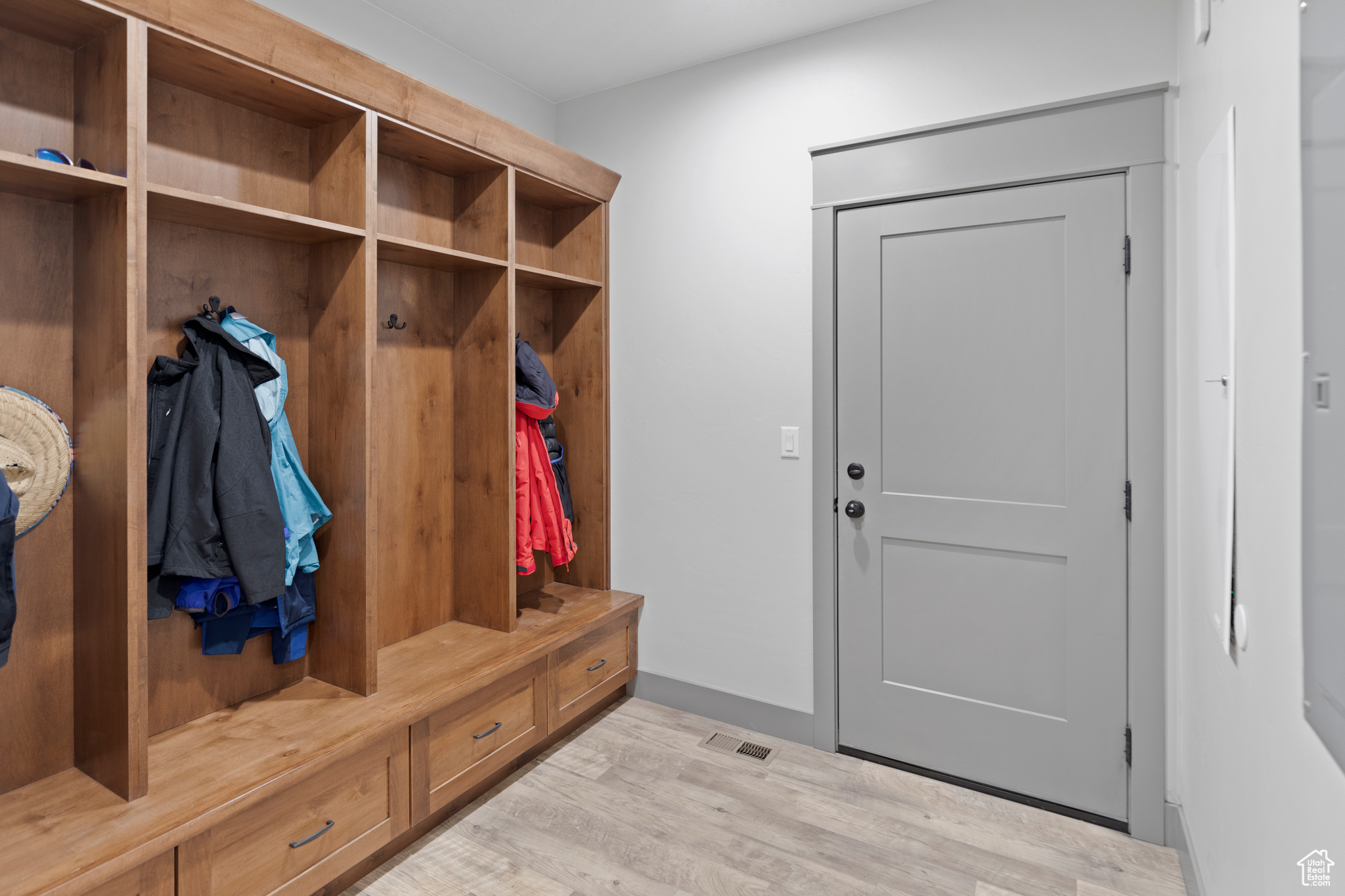 Mudroom with light hardwood / wood-style floors