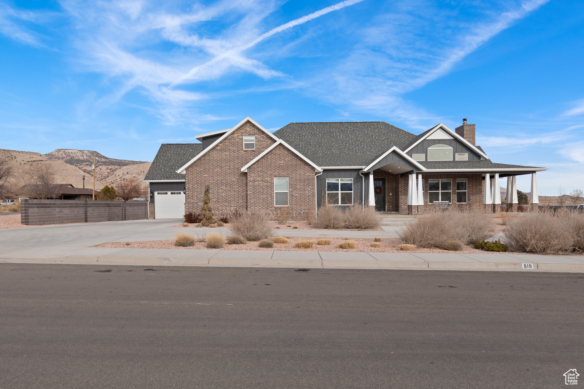 View of front of property with a garage and a mountain view