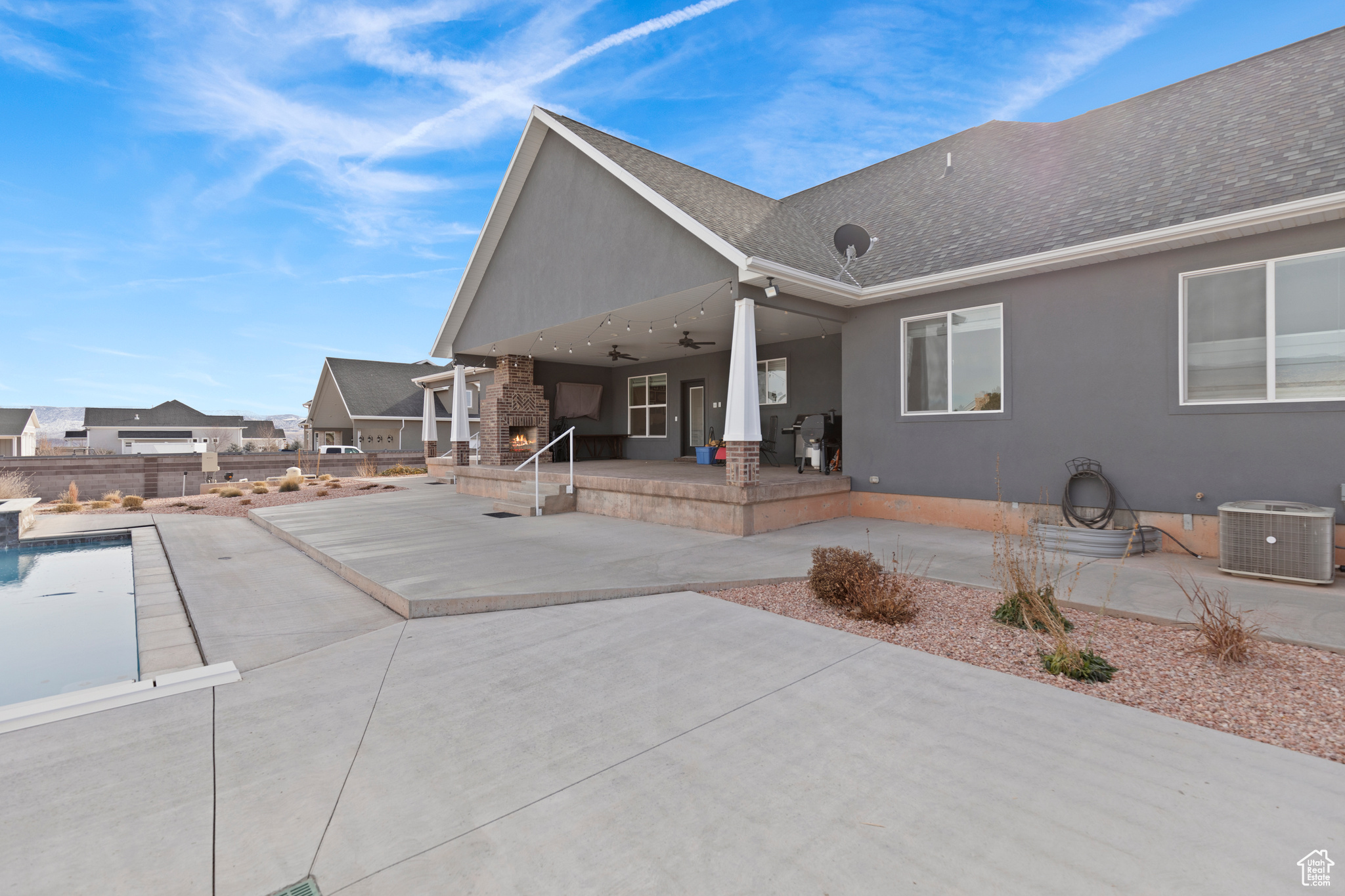 Rear view of house featuring a patio and central AC