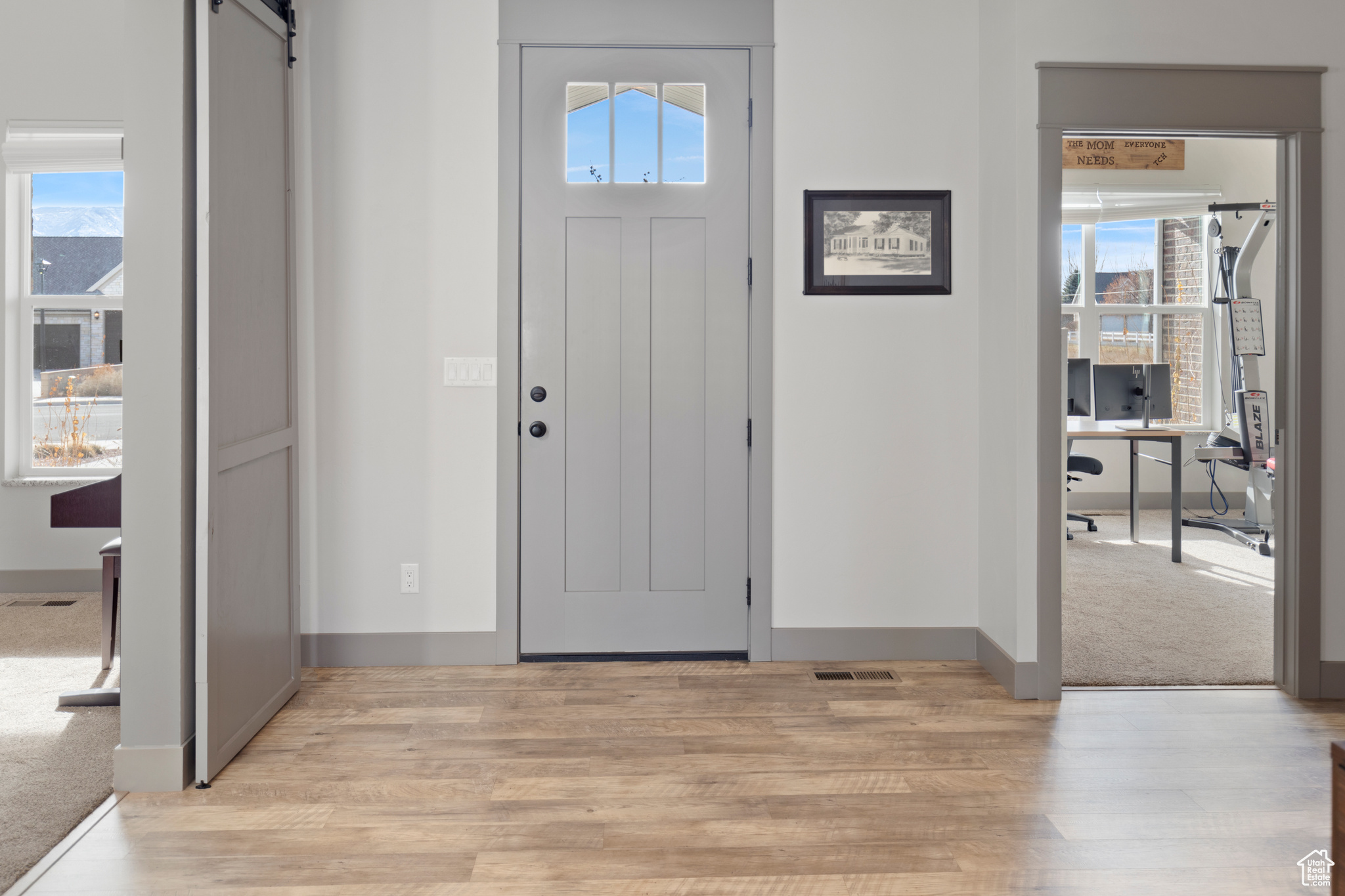 Entryway featuring light wood-type flooring and a barn door