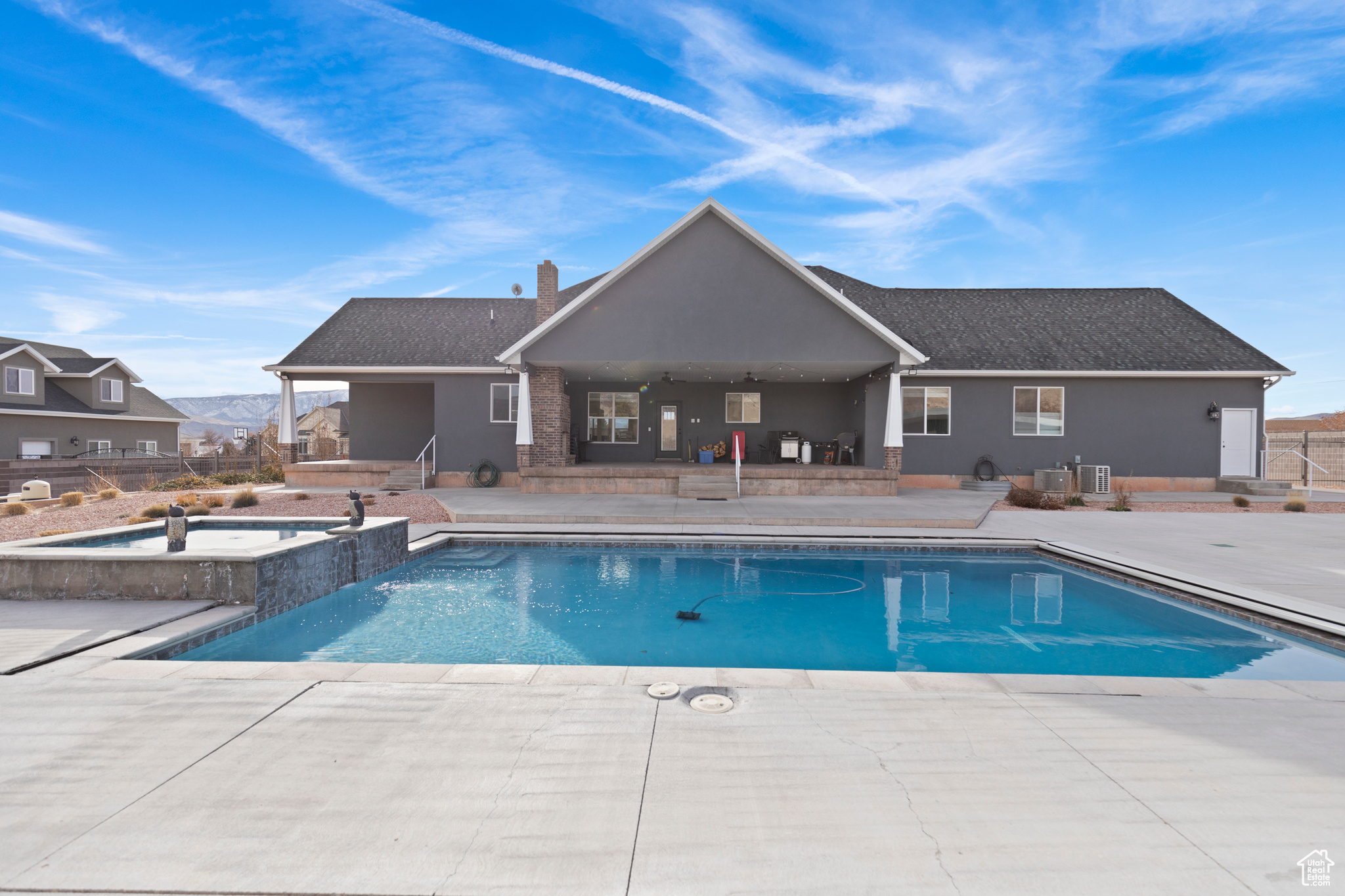 View of pool with central air condition unit, an in ground hot tub, and a patio