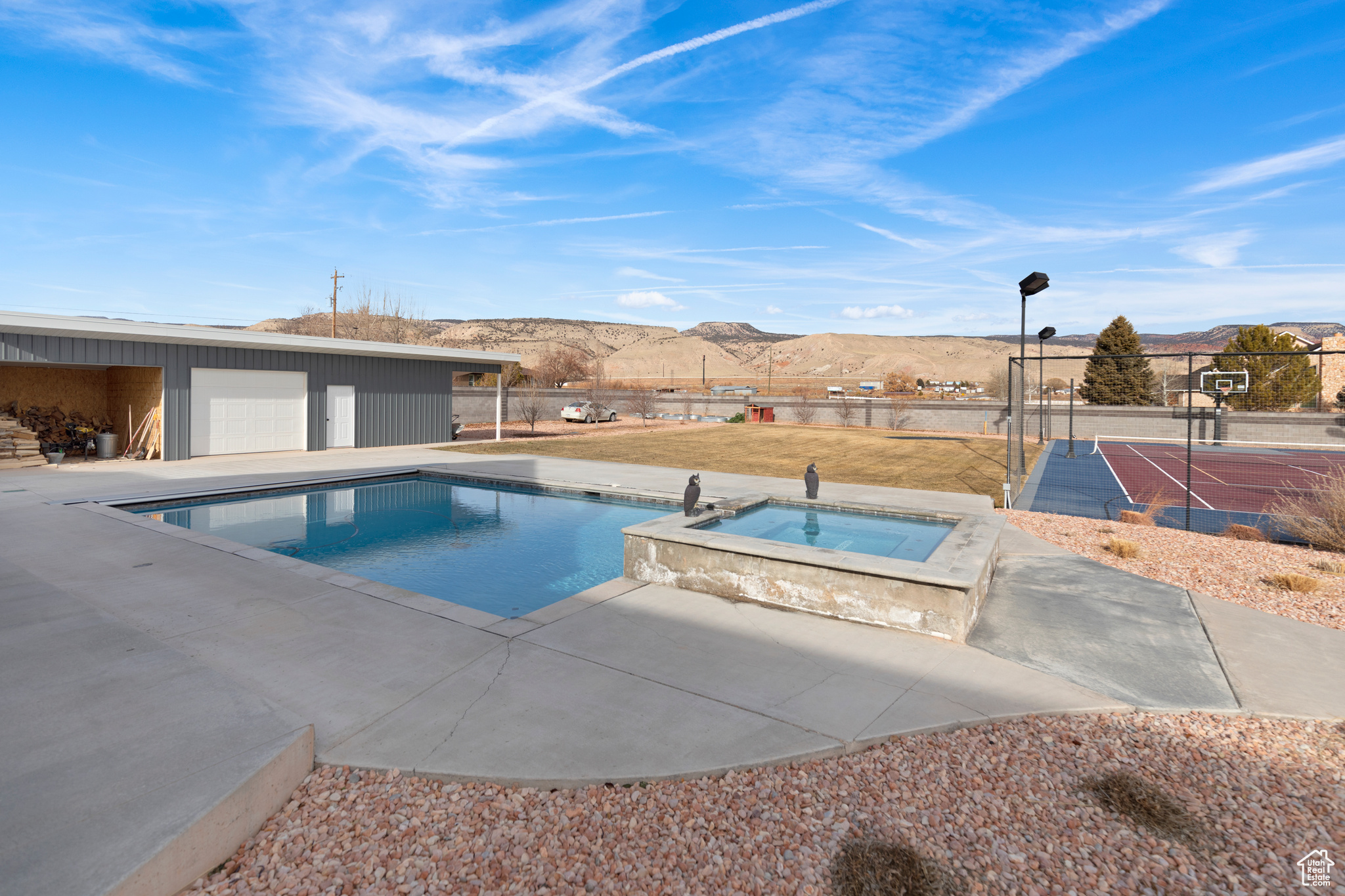 View of pool featuring a mountain view and an in ground hot tub