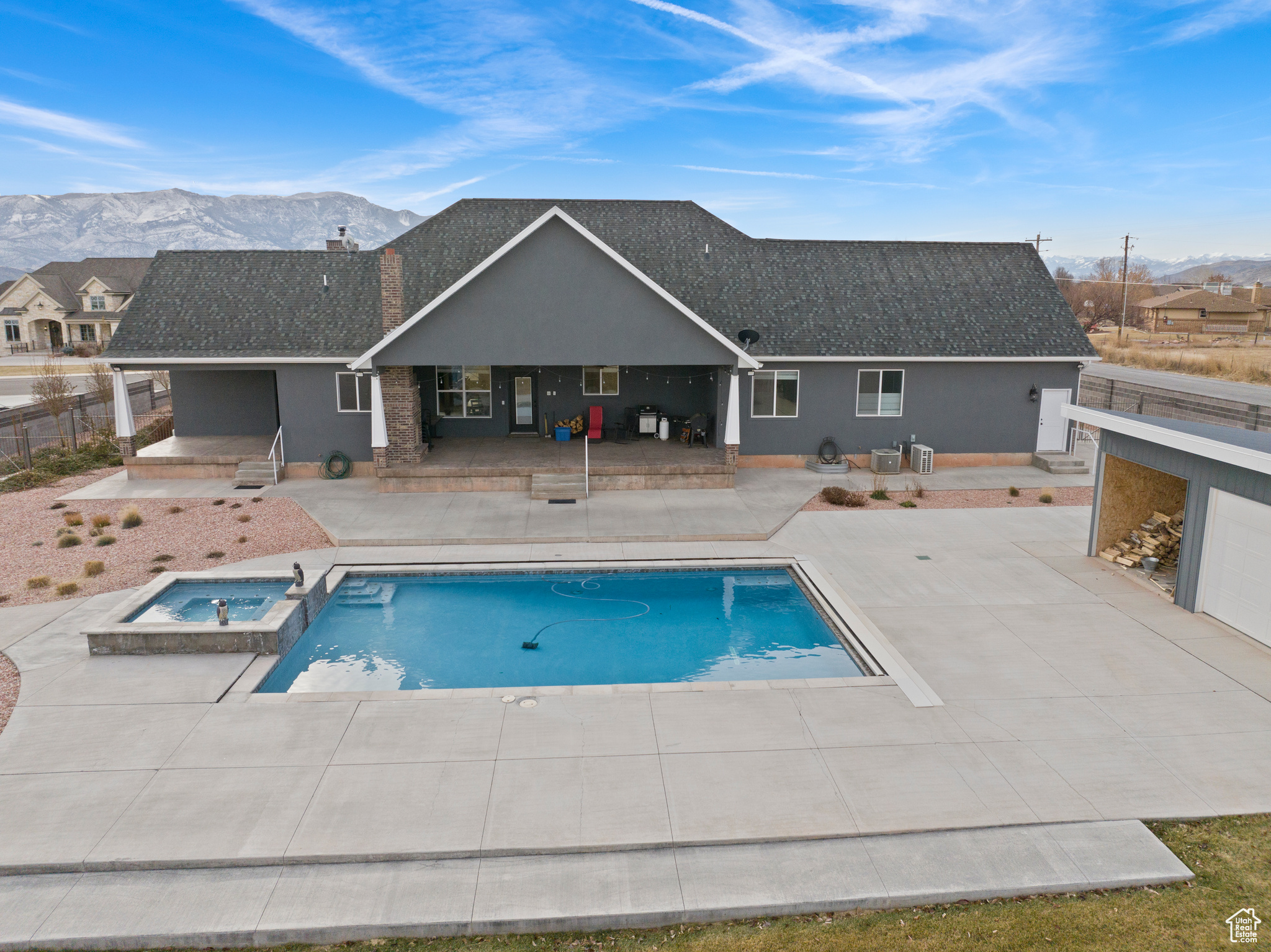 View of pool with an in ground hot tub, a patio, and a mountain view