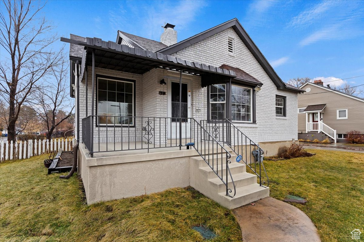 Bungalow-style house featuring a front yard