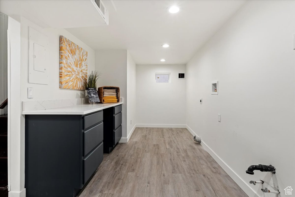 Laundry area featuring washer hookup, light hardwood / wood-style floors, and electric dryer hookup