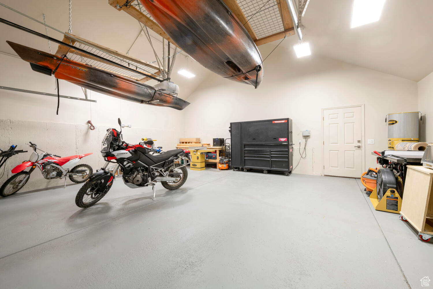 Garage featuring extra height and width w/garage door opener and person door access to the backyard