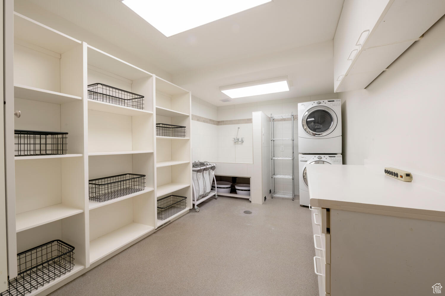 Laundry room w/spacious locker style closets with stacker washer/dryer and pet wash