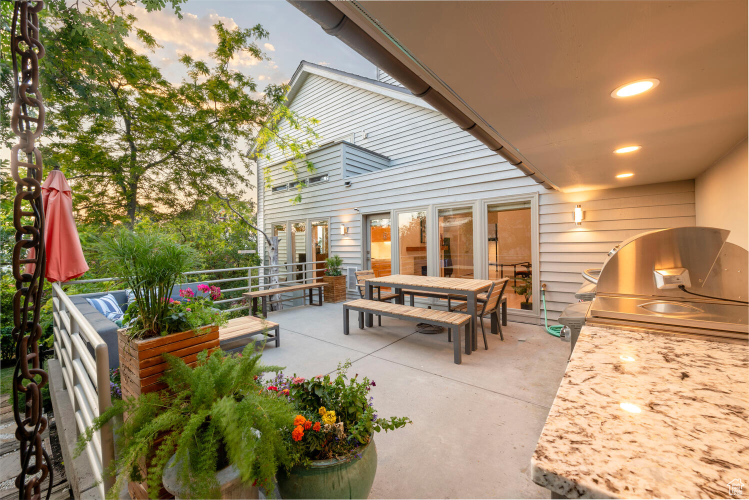 Patio at twilight featuring outdoor kitchen