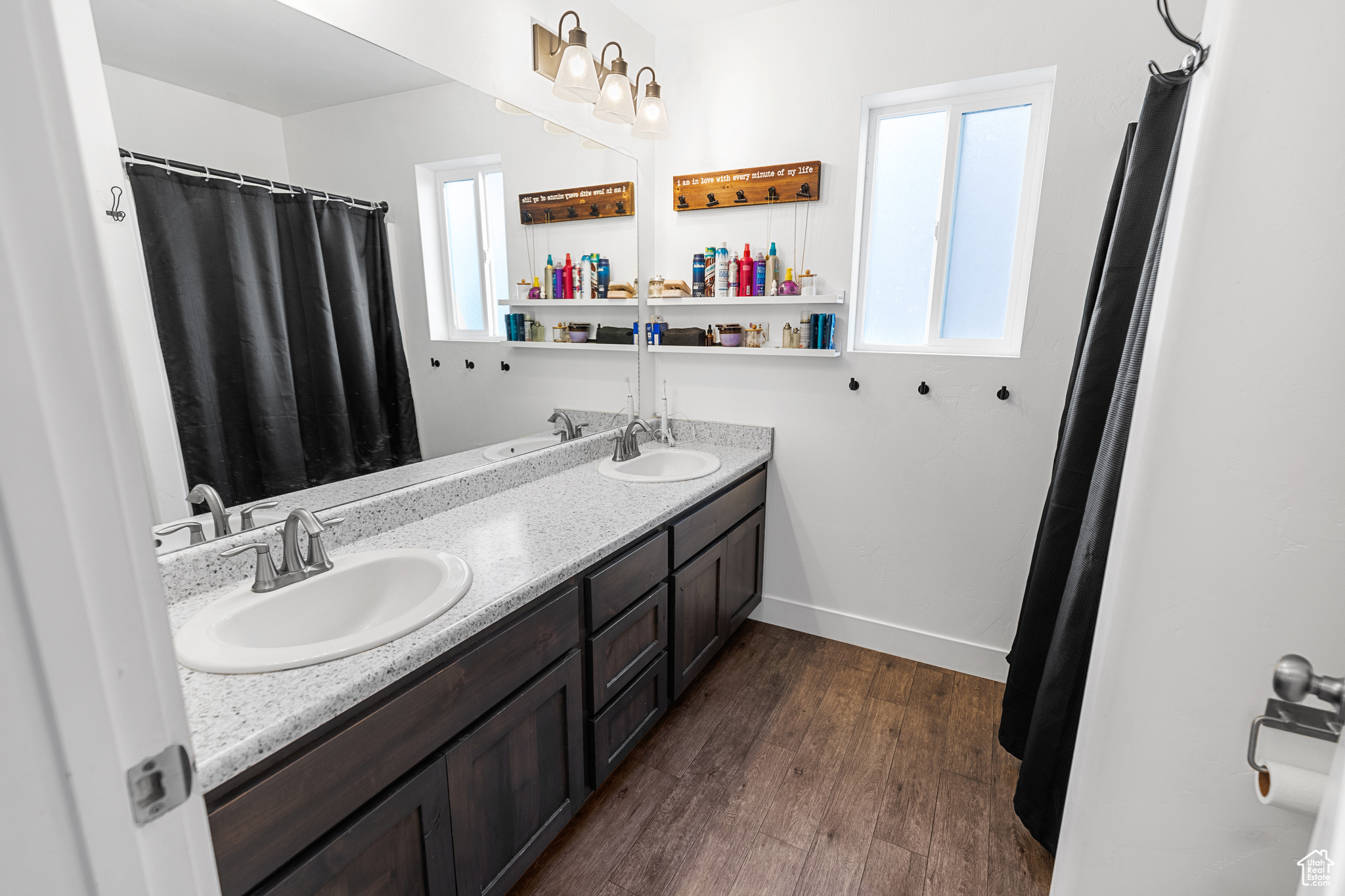 Bathroom with double sink vanity and hardwood / wood-style floors