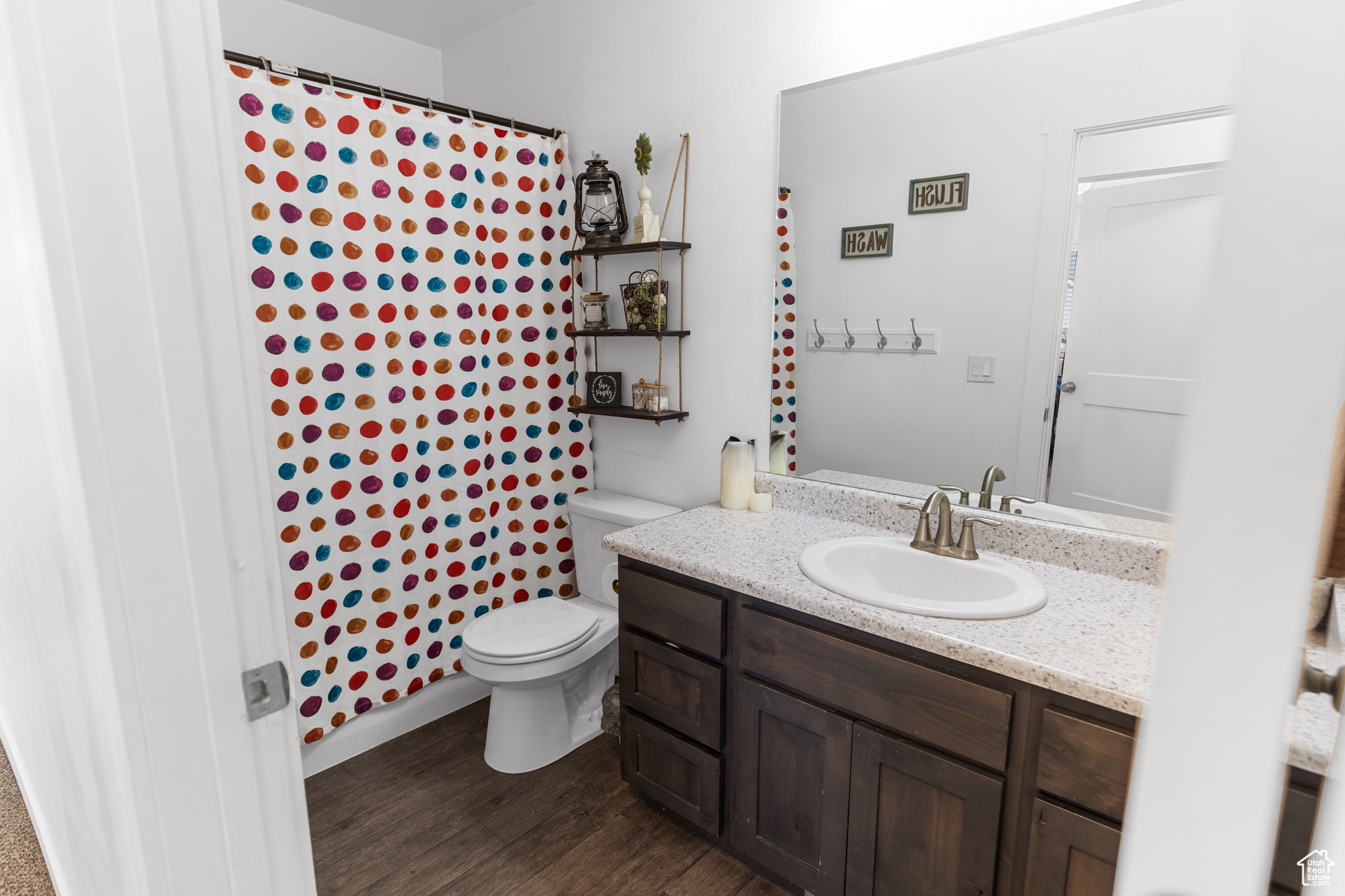 Bathroom featuring oversized vanity, toilet, and hardwood / wood-style floors