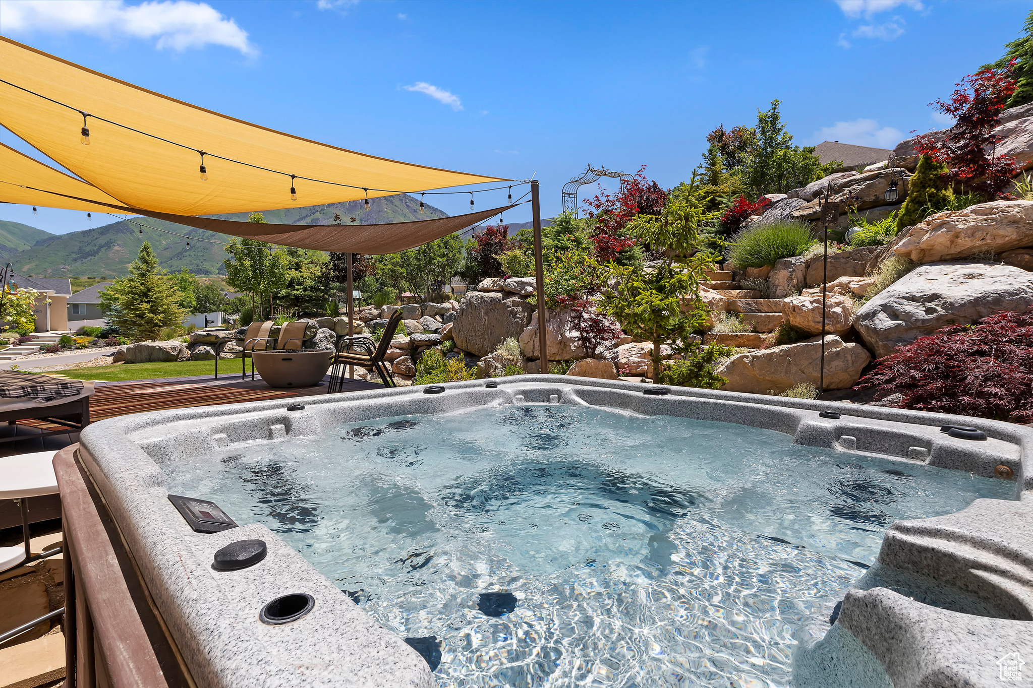 View of swimming pool featuring a mountain view and a hot tub