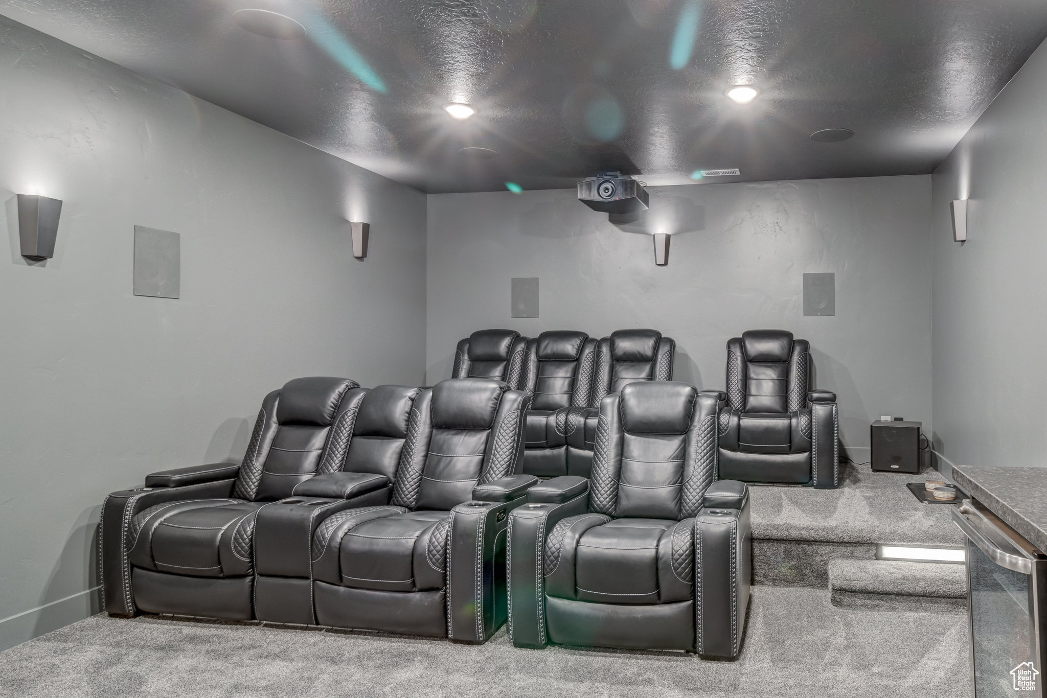 Carpeted cinema featuring ceiling fan
