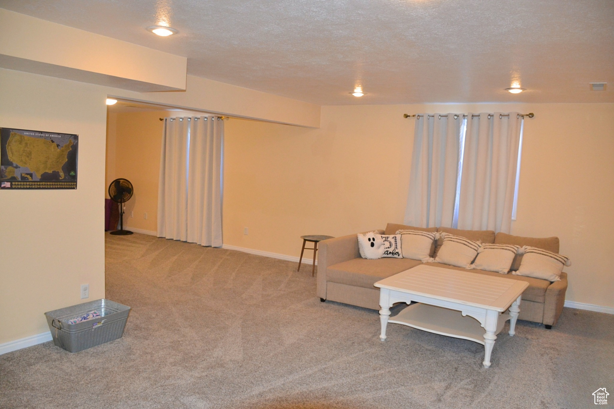 Carpeted living room featuring a textured ceiling