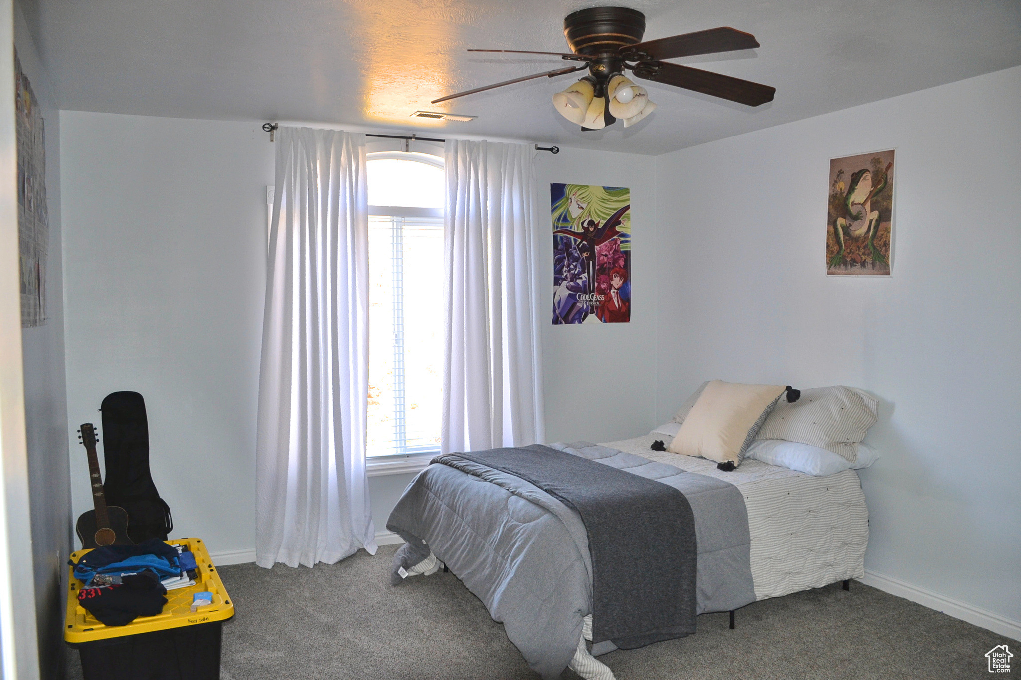 Carpeted bedroom with ceiling fan